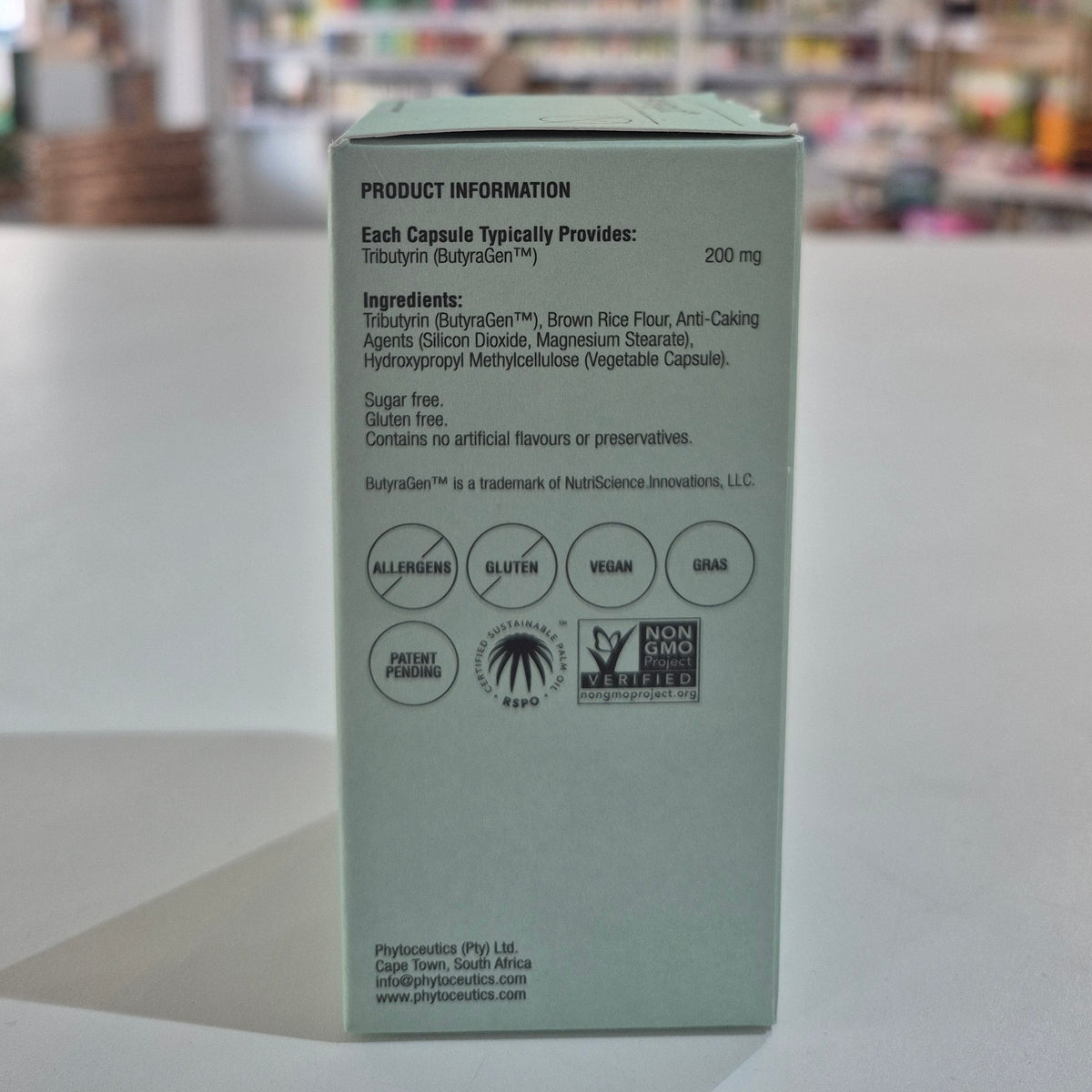 Back of a green supplement capsule packaging with product information and labels.