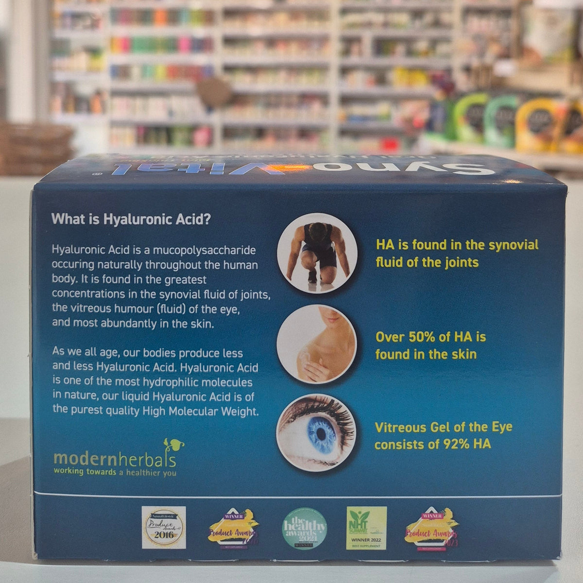 Product packaging with text and images on a blurred store background