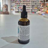 Bottle of Viridian Vitamin D3 & K2 Liquid on a table with a blurred store background. Bottle with dropper on a surface with a blurred background