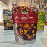A stand-up pouch of Dj&A Shitake Mushroom Crisps in Smoked Chilli & Garlic Flavour, displayed on a white countertop with two other Dj&A snack pouches in the background.