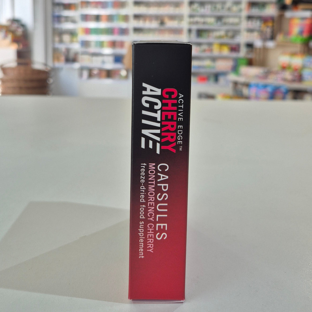 Box of Cherry Active capsules with a blurred background
