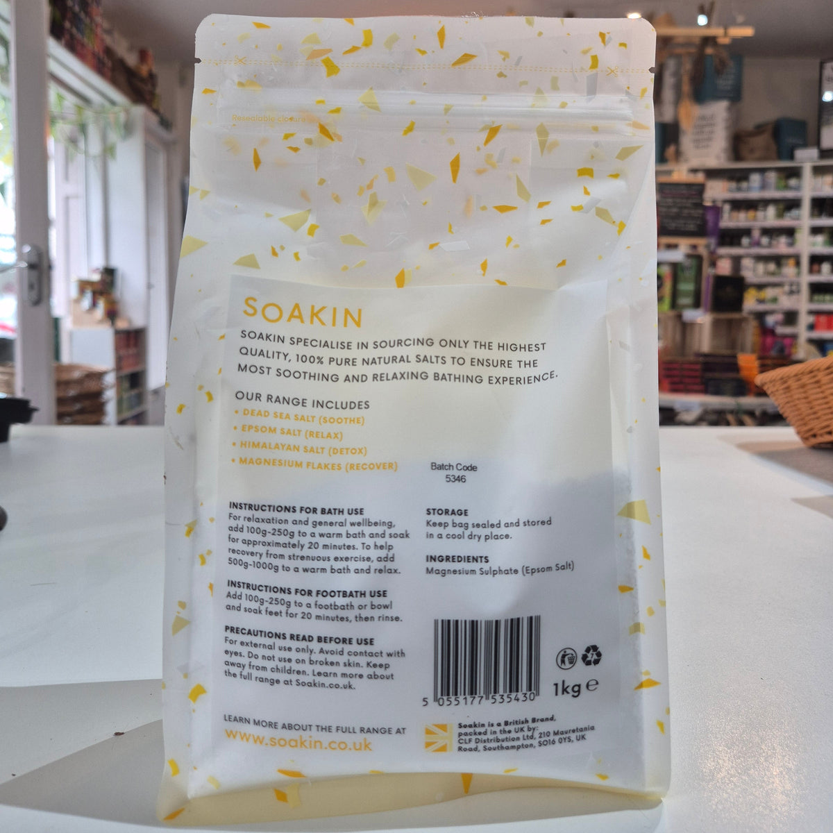 A pack of Soakin Epsom salt, with the branding visible on the front. The packaging is clear, allowing the reader to see the product inside.