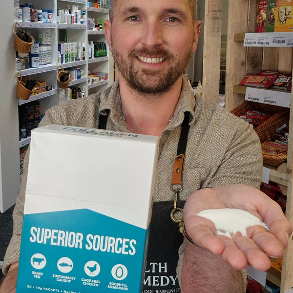 Man holding a product from 'Superior Sources' in a store setting