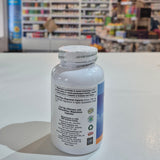 Bottle with label on a white surface, blurred background of a store interior.