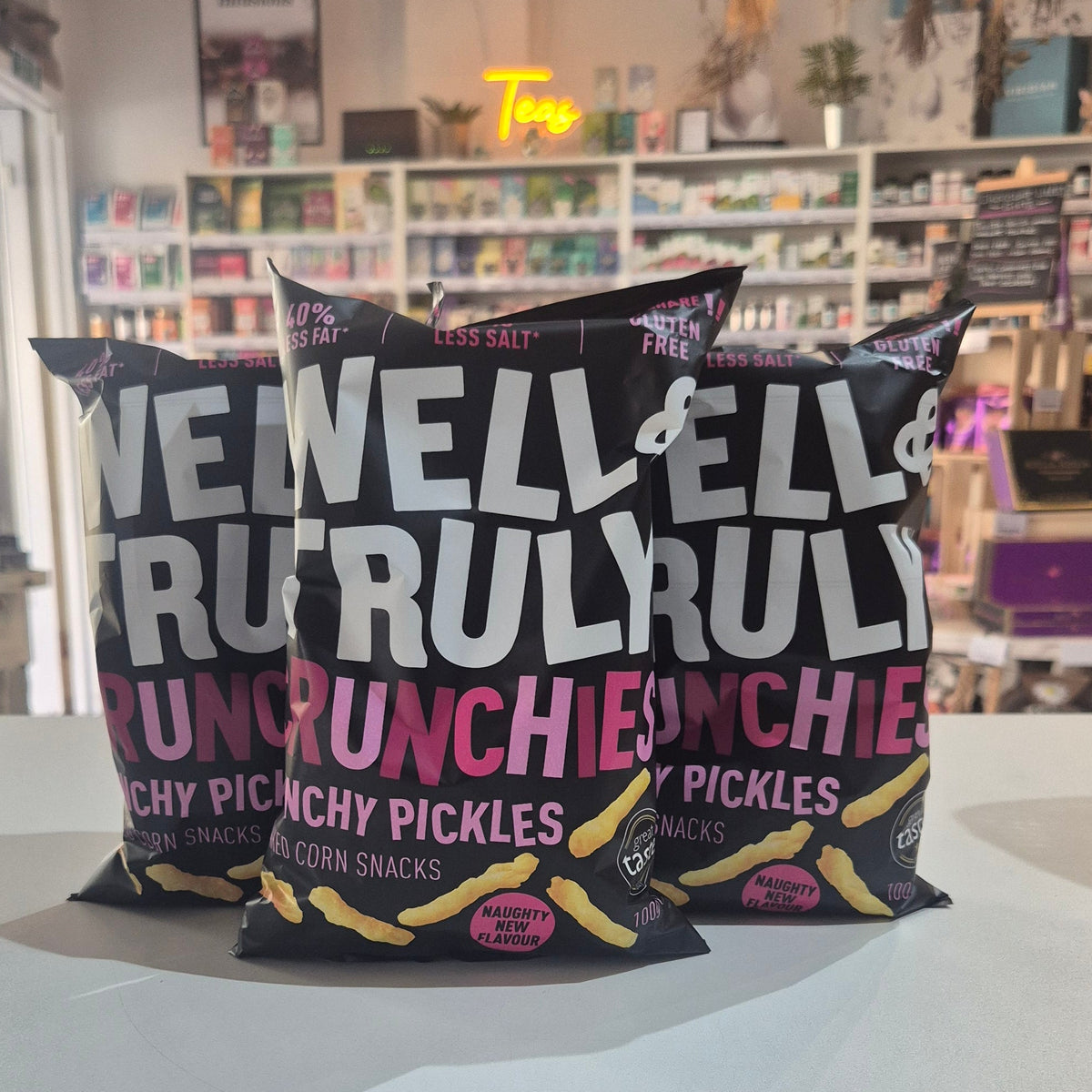 A bag of Well & Truly Crunchies Crunchy Pickles snack chips 3 packs