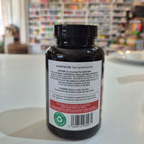 Bottle with label on a white surface, blurred background