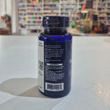 Bottle with a blue label on a white surface, blurred background