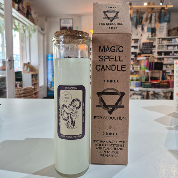 Candle with packaging labeled 'Magic Spell Candle' in a store setting