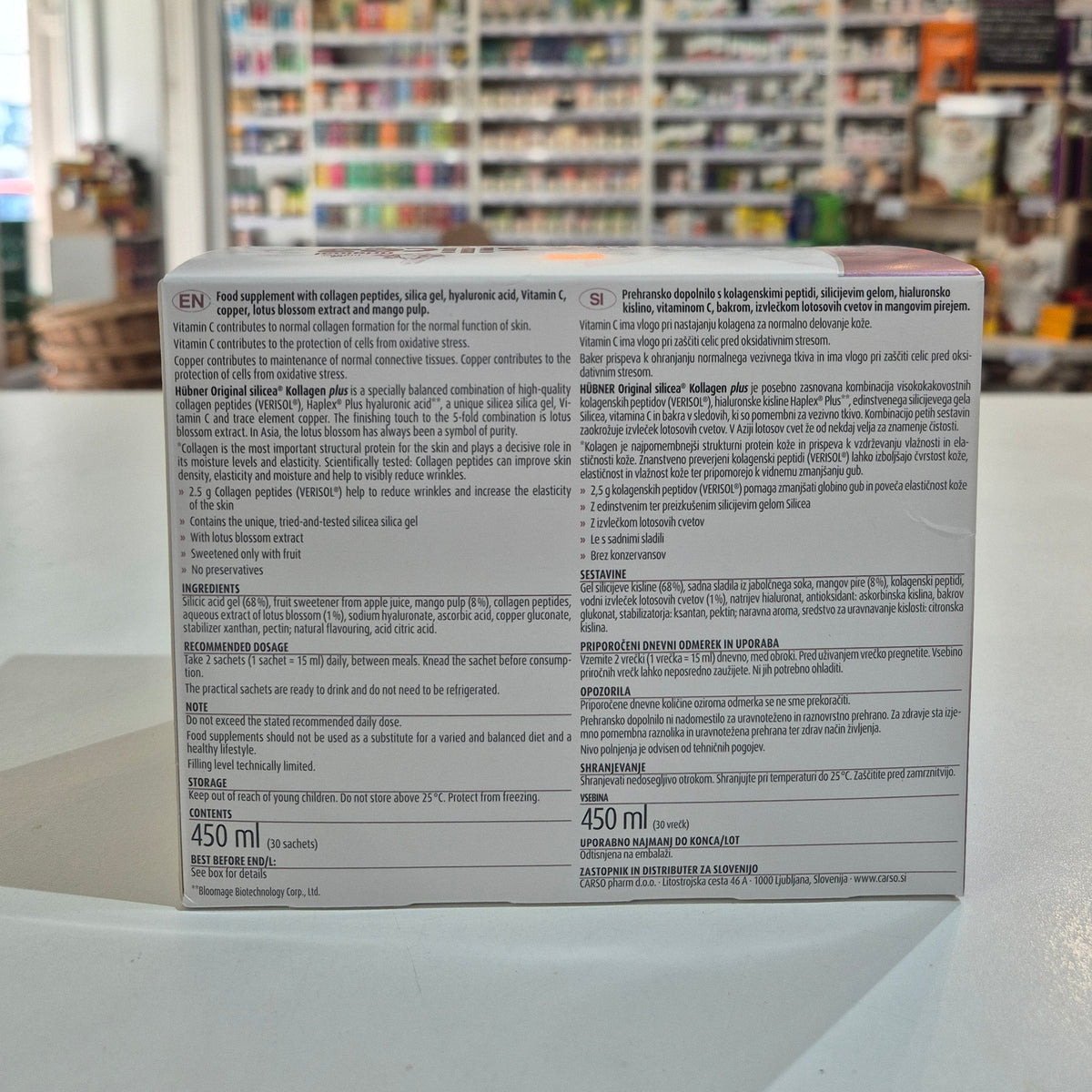 Supplement box with text on a blurred store shelf background