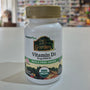 Nature's Plus Vitamin D3 supplement bottle on a white surface with a blurred background