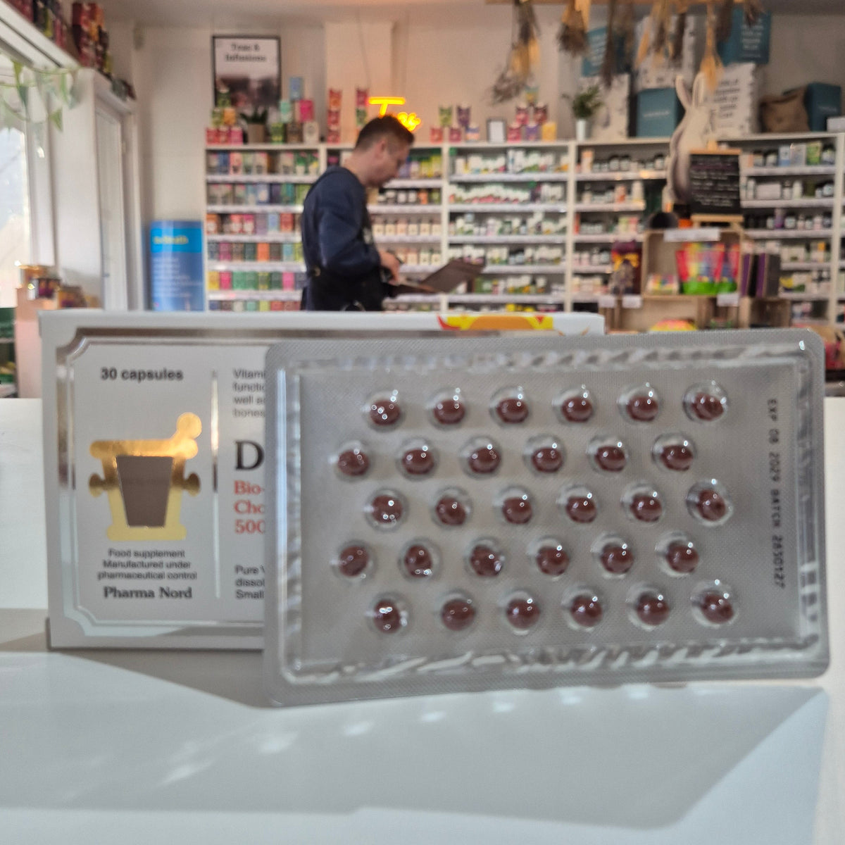 Supplement packaging with visible branding in a store setting