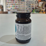 Brown supplement bottle with label on a white surface, blurred store background