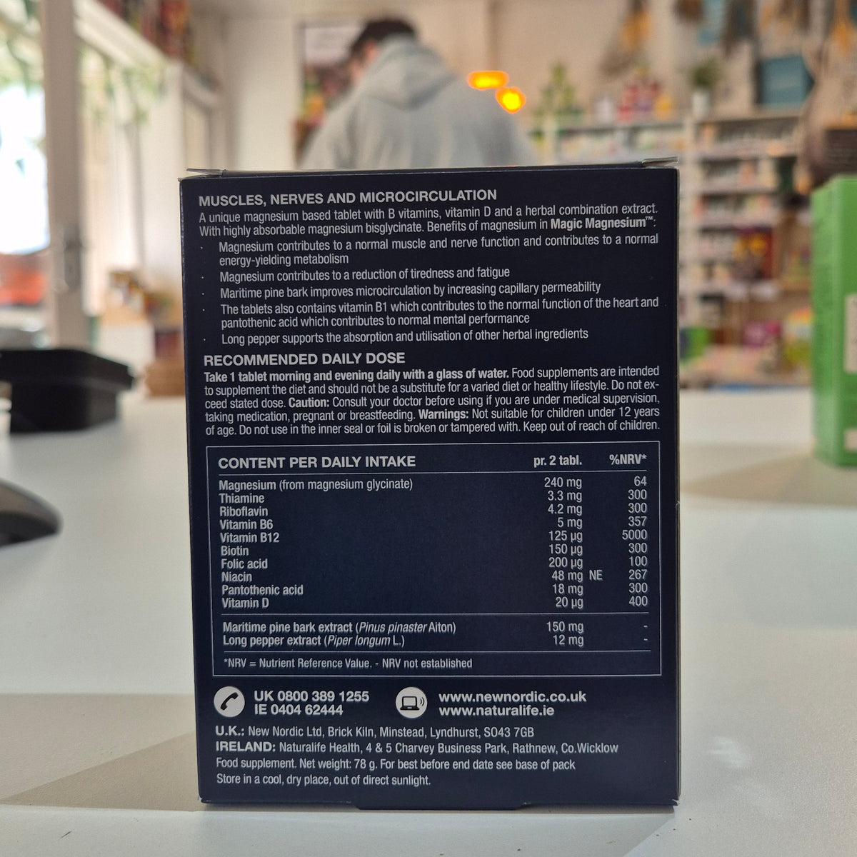 Nutritional supplement box. Box of New Nordic Magic Magnesium Glycinate 600 mg supplement on a blurred store shelf background