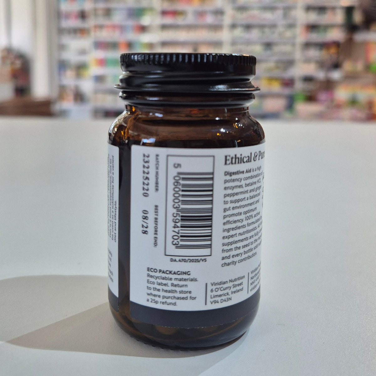 Brown glass bottle with a label on a white surface