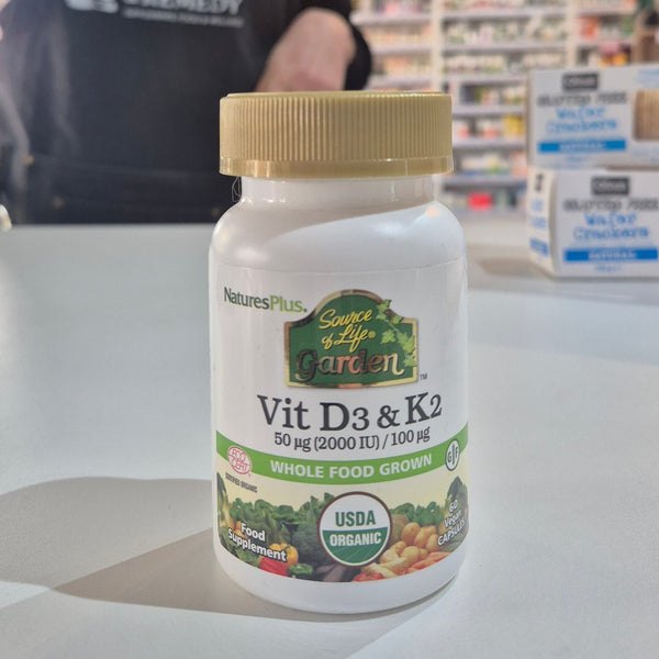 Nature's Plus Source of Life Garden Vit D3 & K2 supplement bottle on a counter.