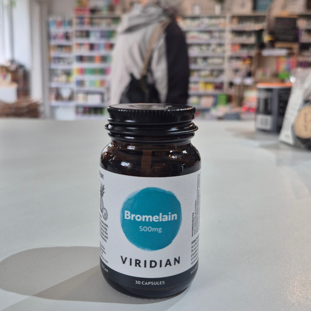 Bottle of Viridian Bromelain 500mg on a counter in a store setting