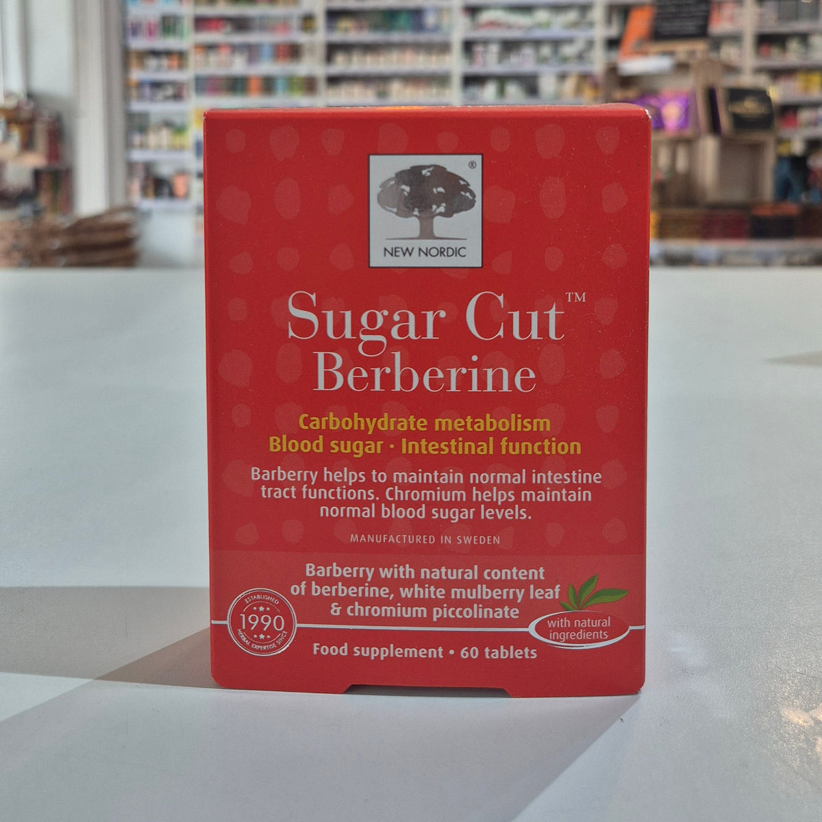 'Sugar Cut Berberine' held against a blurred bookstore background