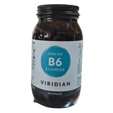Jar of Viridian High Six B6 B-Complex supplement on a counter with a blurred store background.