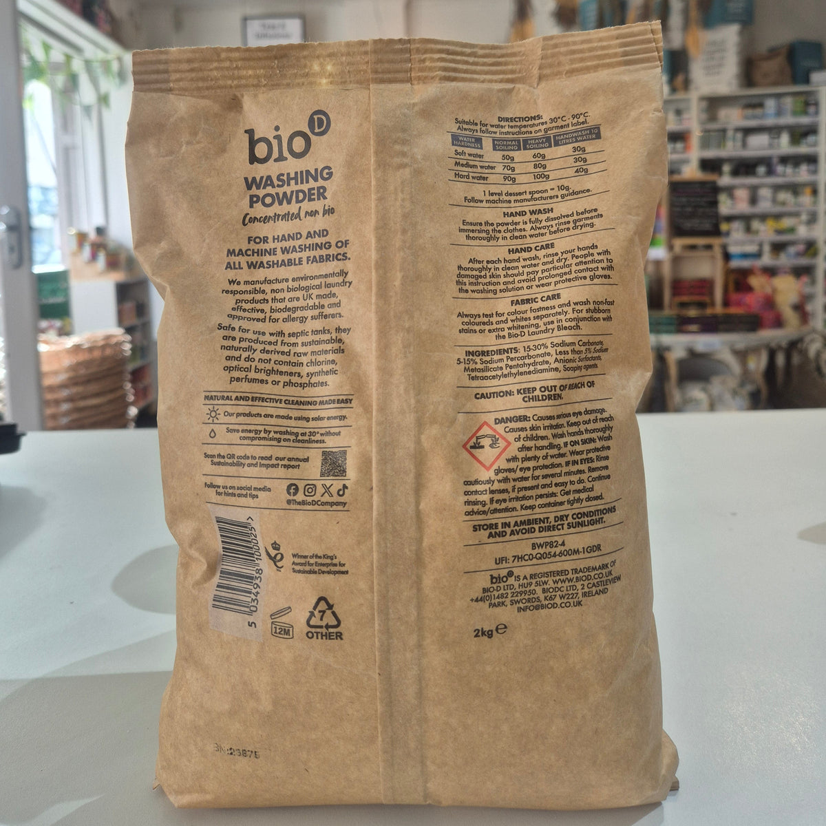 Brown paper bag with text and logos on a white surface