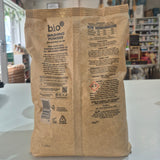 Brown paper bag with text and logos on a white surface