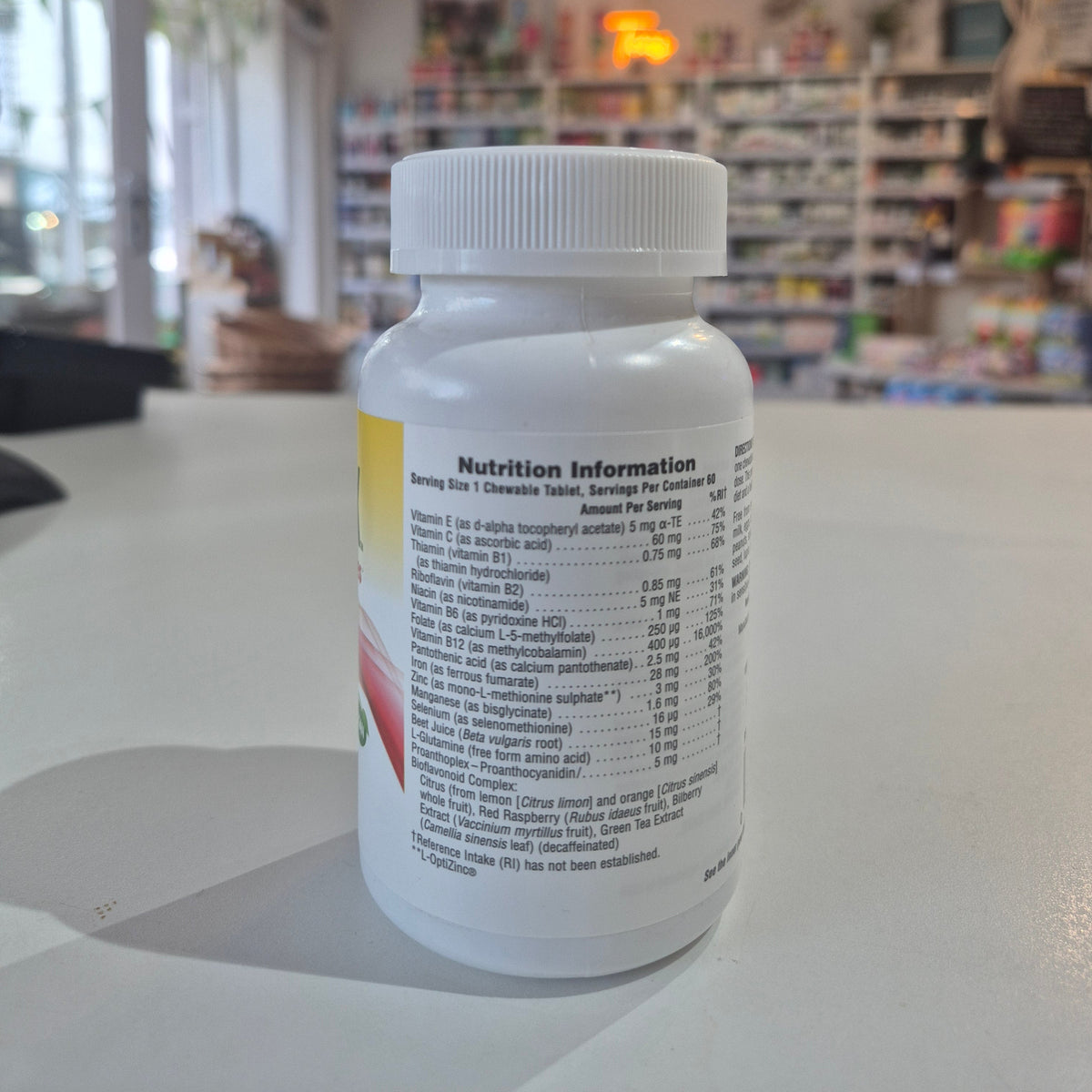 Supplement bottle with nutrition information label on a counter in a store setting