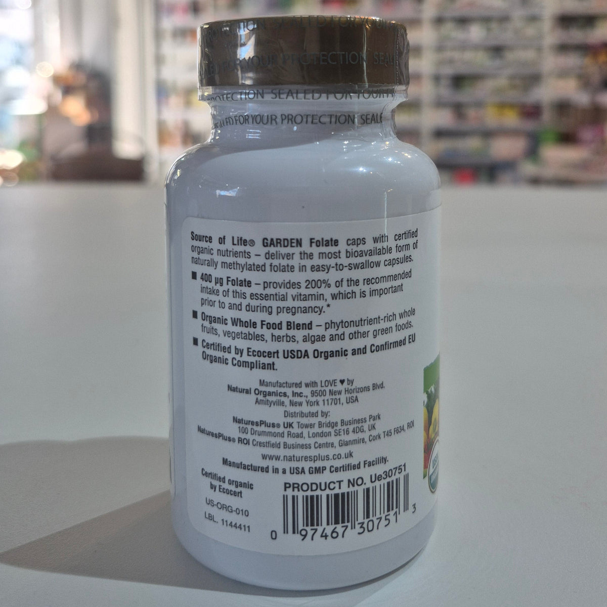 Supplement bottle with label text on a blurred background