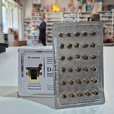 Packaging of capsules with a blurred indoor background
