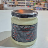 Jar of cream with a blurred store interior in the background