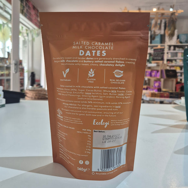 Brown package of salted caramel milk chocolate dates on a white surface with a blurred background