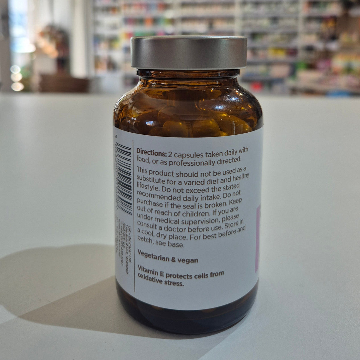 Vitamin supplement bottle with label on a blurred background