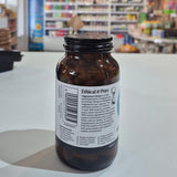 Brown bottle with a label on a white surface in a store setting