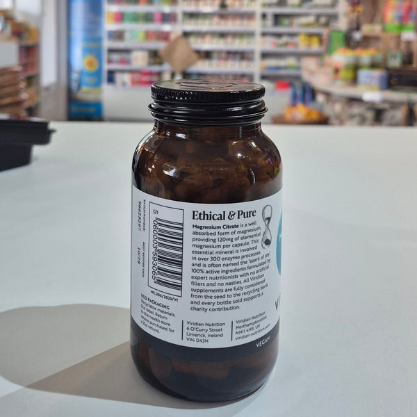 Brown bottle with a label on a white surface in a store setting