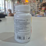 White supplement bottle with label on a blurred store background