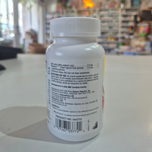 White supplement bottle with label on a blurred store background