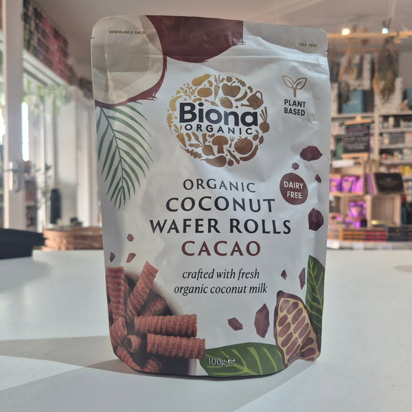 Packaging of Biona Organic Coconut Wafer Rolls Cacao on a white surface with a blurred indoor background.