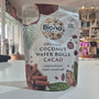 Packaging of Biona Organic Coconut Wafer Rolls Cacao on a white surface with a blurred indoor background.