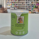 Green canister with a label featuring text and images on a white surface.