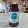 Bottle of Viridian Magnesium Citrate & B6 supplement on a white surface with a blurred store background.
