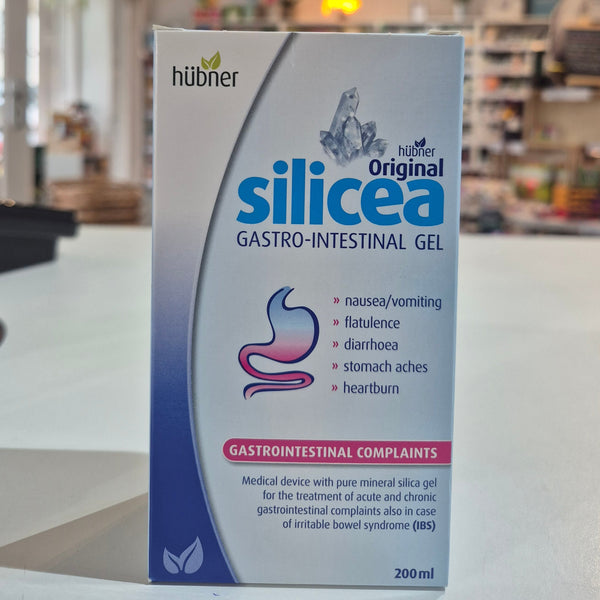 Packaging of Hubner Original Silicea Gi Gel 200Ml for gastro-intestinal complaints, displaying indications such as nausea, vomiting, flatulence, diarrhoea, stomach aches, and heartburn in a shop, on a counter. 