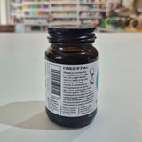 Brown supplement bottle with label on a white surface, blurred store background