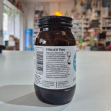 Bottle with a label on a white surface, blurred background