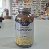 Quest Vegan Glucosamine supplement bottle on a table with a blurred store background