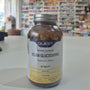 Quest Vegan Glucosamine supplement bottle on a table with a blurred store background