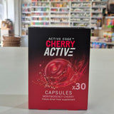 Red and black Montmorency Cherry supplement container with 'CherryActive' branding in a store setting