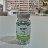 Supplement bottle labeled 'Boron 5mg Sodium Borate' by 'Nature's Truth' on a counter.
