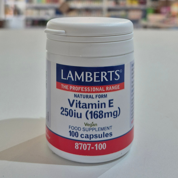 Lamberts Vitamin E supplement container on a table with a blurred background
