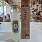 Candle with a decorative label and packaging on a white surface