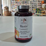 Bottle of New Nordic Biotin Gummies with peach flavor label on a counter.
