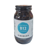 Jar of Viridian High Twelve B12 B-Complex supplement on a white surface with a blurred store background.